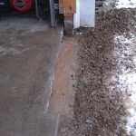 We cut the concrete slab to expose the footings to install new concrete block